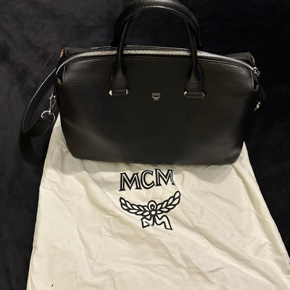 MCM black bag w/ top handles and crossbody/shoulder/strap. Silver fixtures.